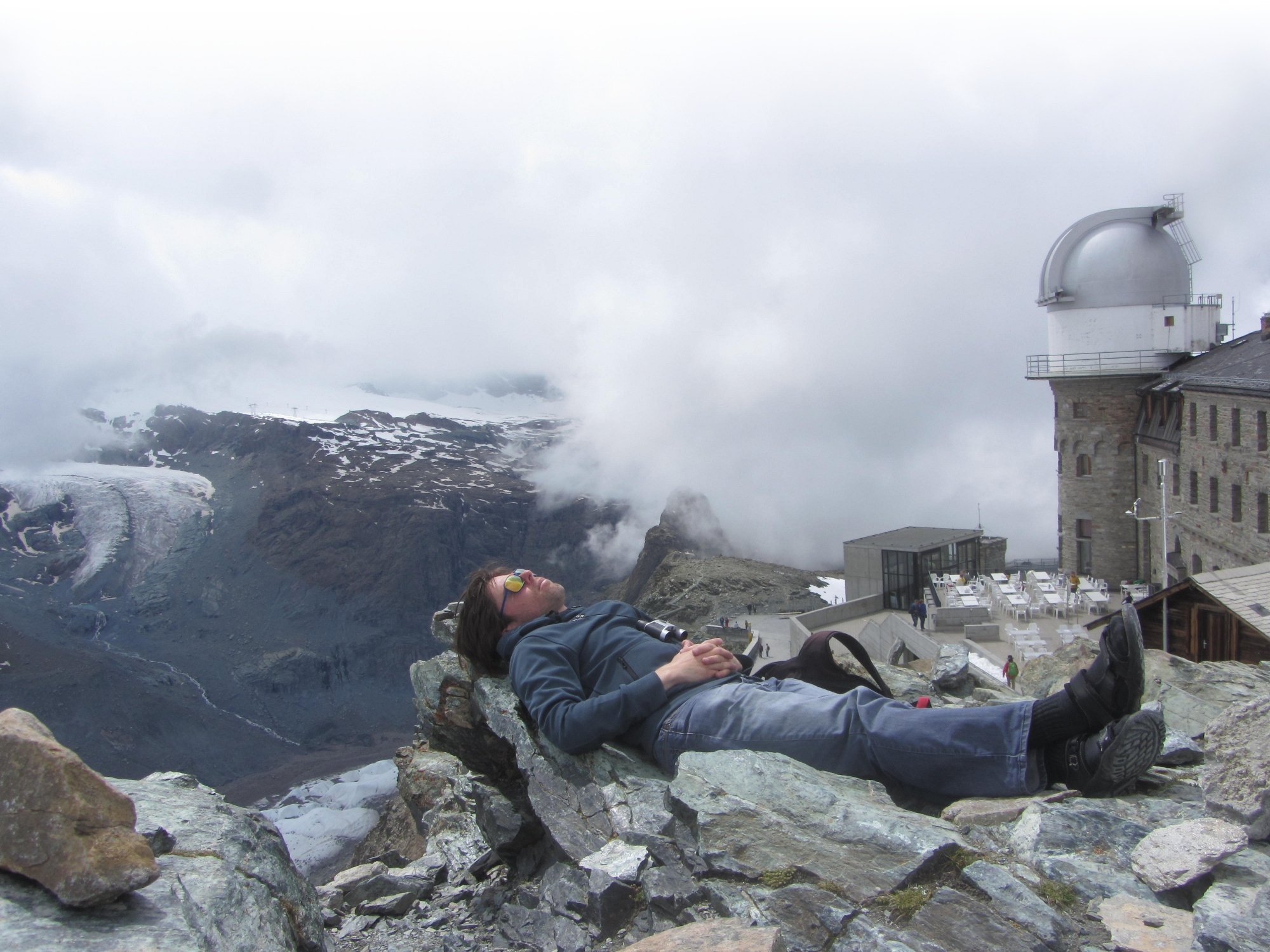 lying on the rocks with a view on the Gornergrat glaciers after reaching them on foot